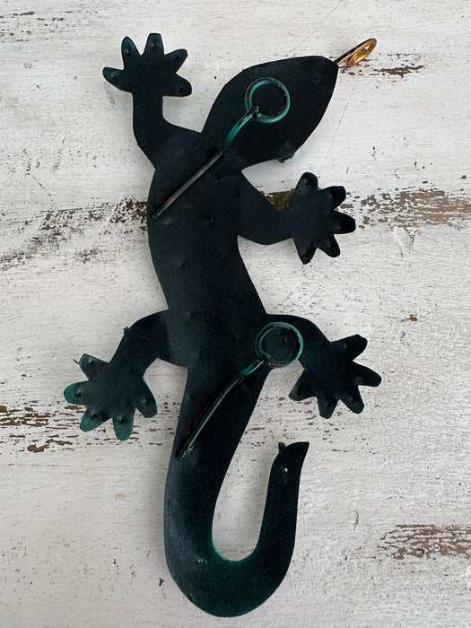 aerial back view of metal gecko with hooks attached