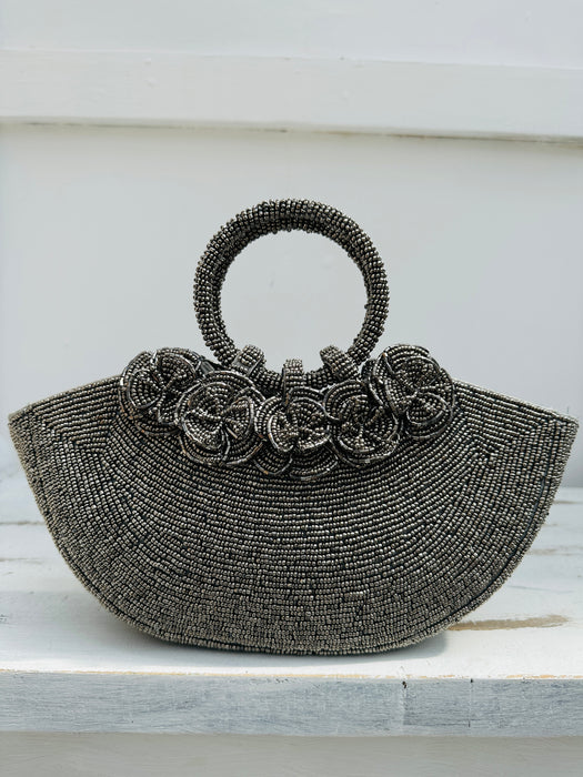 front view of beaded handbag with beaded flowers attached