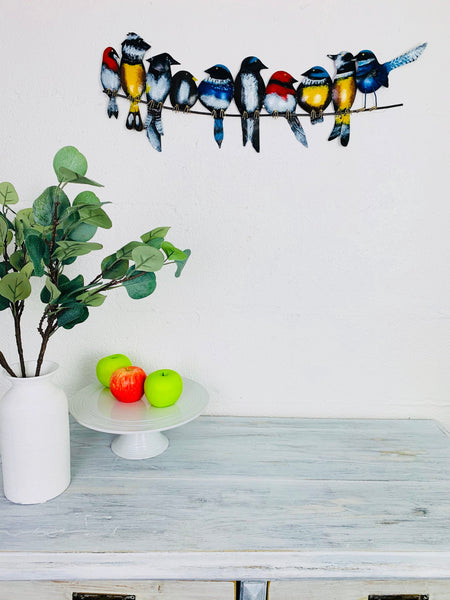 display view of metal birds hung on wall