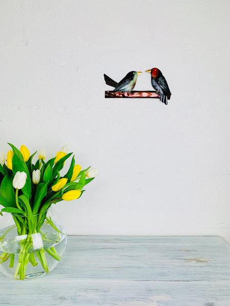 display view of two birdies hung on wall