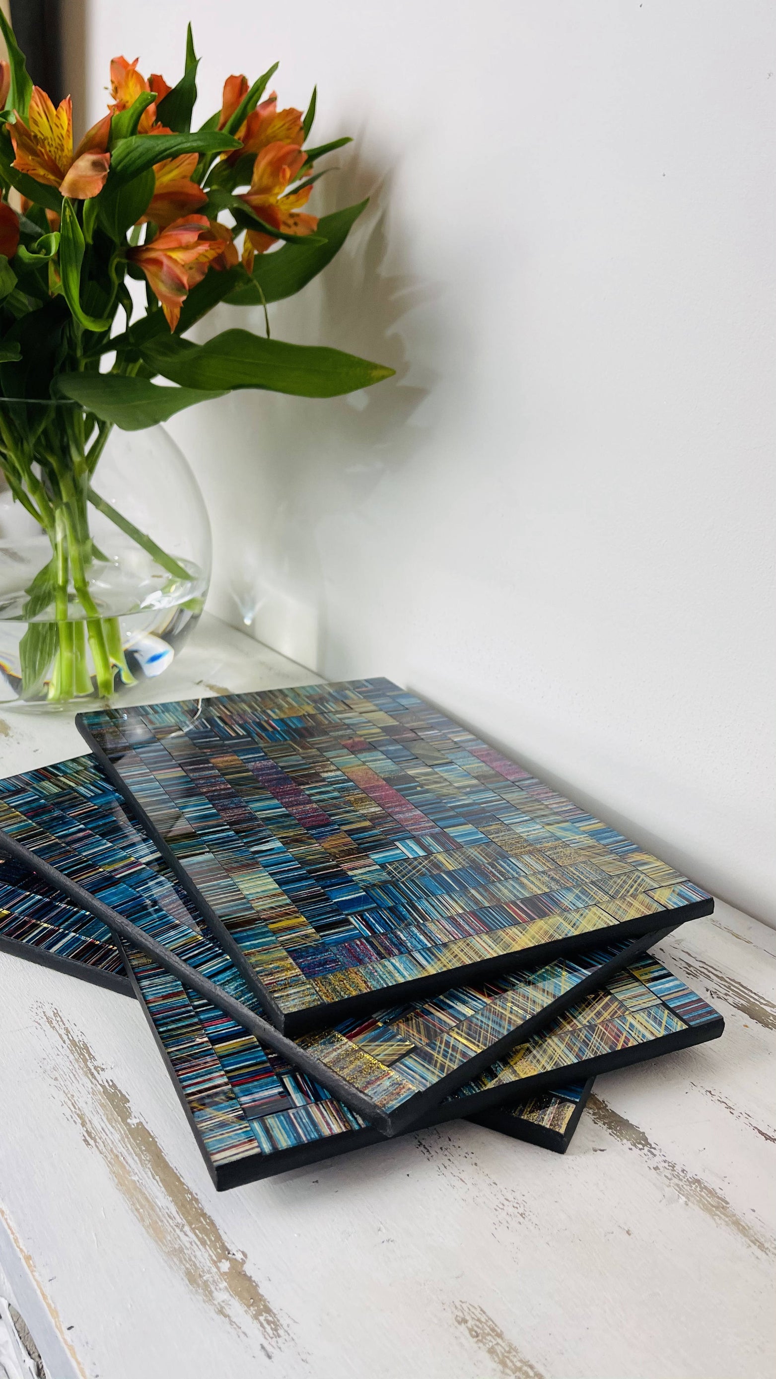 side view of set of mosaic placemats in blue